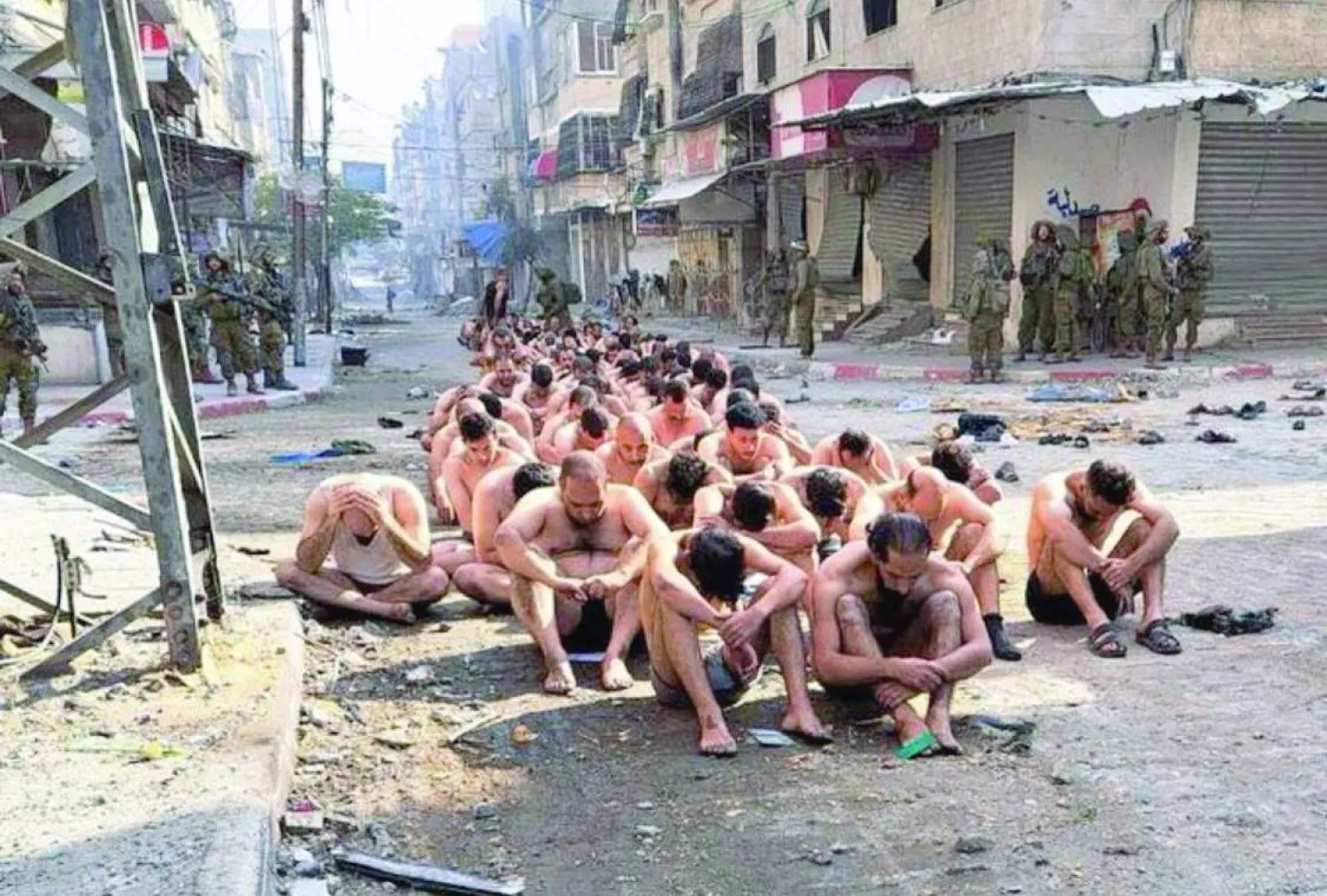 صورة من بيت لاهيا لعشرات الفلسطينيين المعتقلين وهم شبه عراة (رويترز)