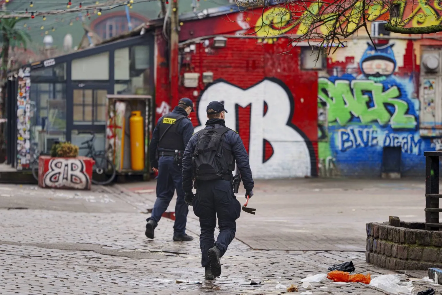 Police officers work on the closure of Pusher Street in Christiania, a community of Copenhagen, Denmark, on March 20, 2024 (EPA) Police officers work on the closure of Pusher Street in Christiania, a community of Copenhagen, Denmark, on March 20, 2024 (EPA) 