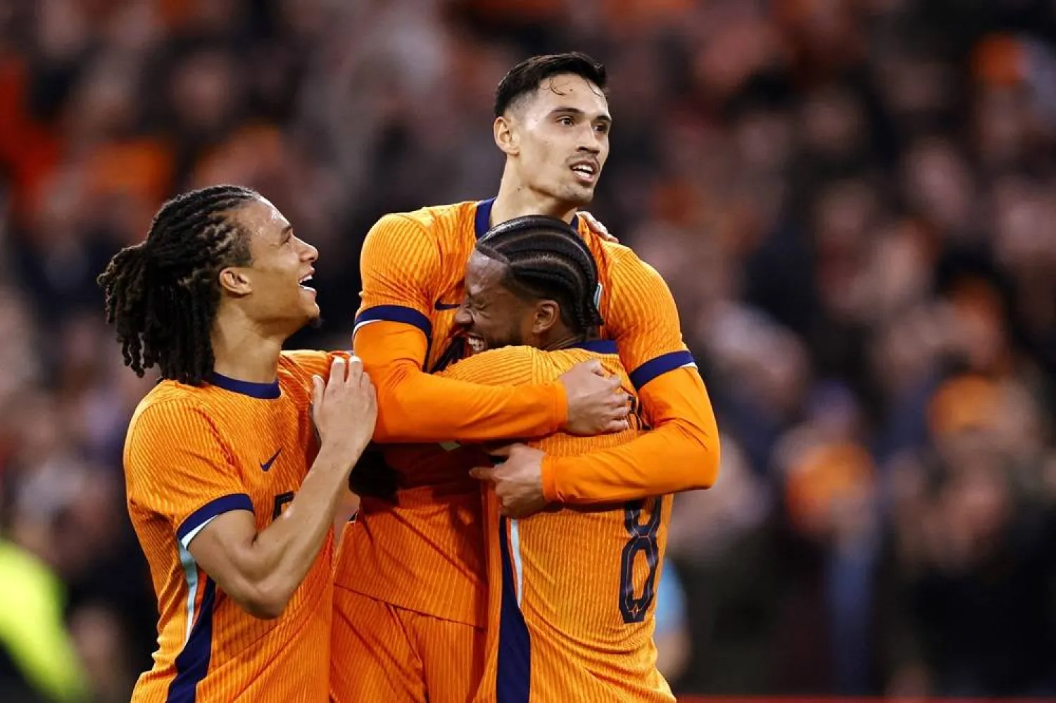 Netherlands' midfielder #14 Tijjani Reijnders (C) celebrates scoring the Netherlands first goal with Netherlands' defender #05 Nathan Ake (L) and Netherlands' midfielder #08 Georginio Wijnaldum (R) during the international friendly football match between the Netherlands and Scotland at the Johan Cruijff Arena in Amsterdam on March 22, 2024. (AFP)  