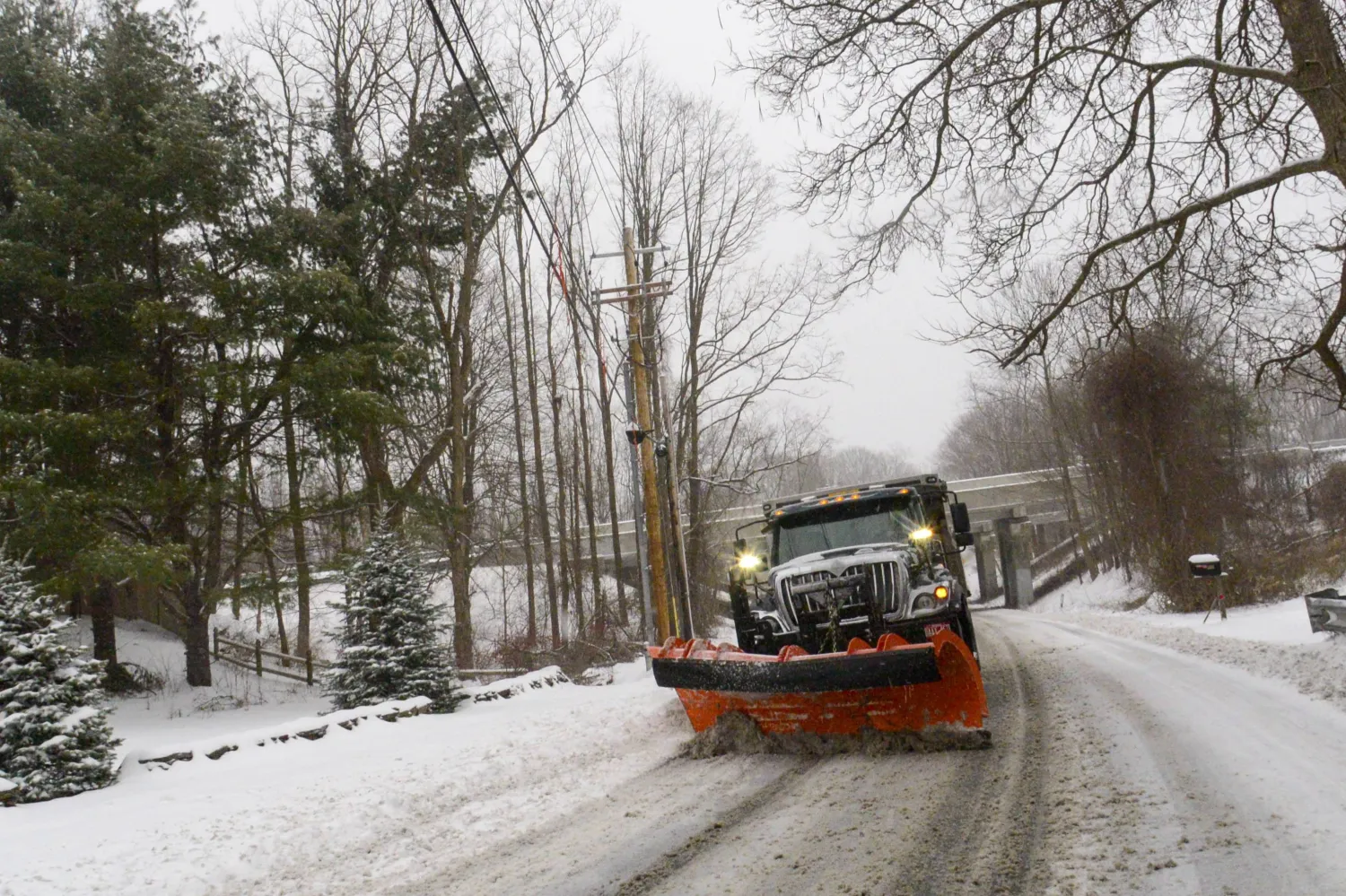 A snowplow removes the snow on Maple Street in Brattleboro, Vt., while the snow falls on Saturday, March 23, 2024. (Kristopher Radder /The Brattleboro Reformer via AP)
