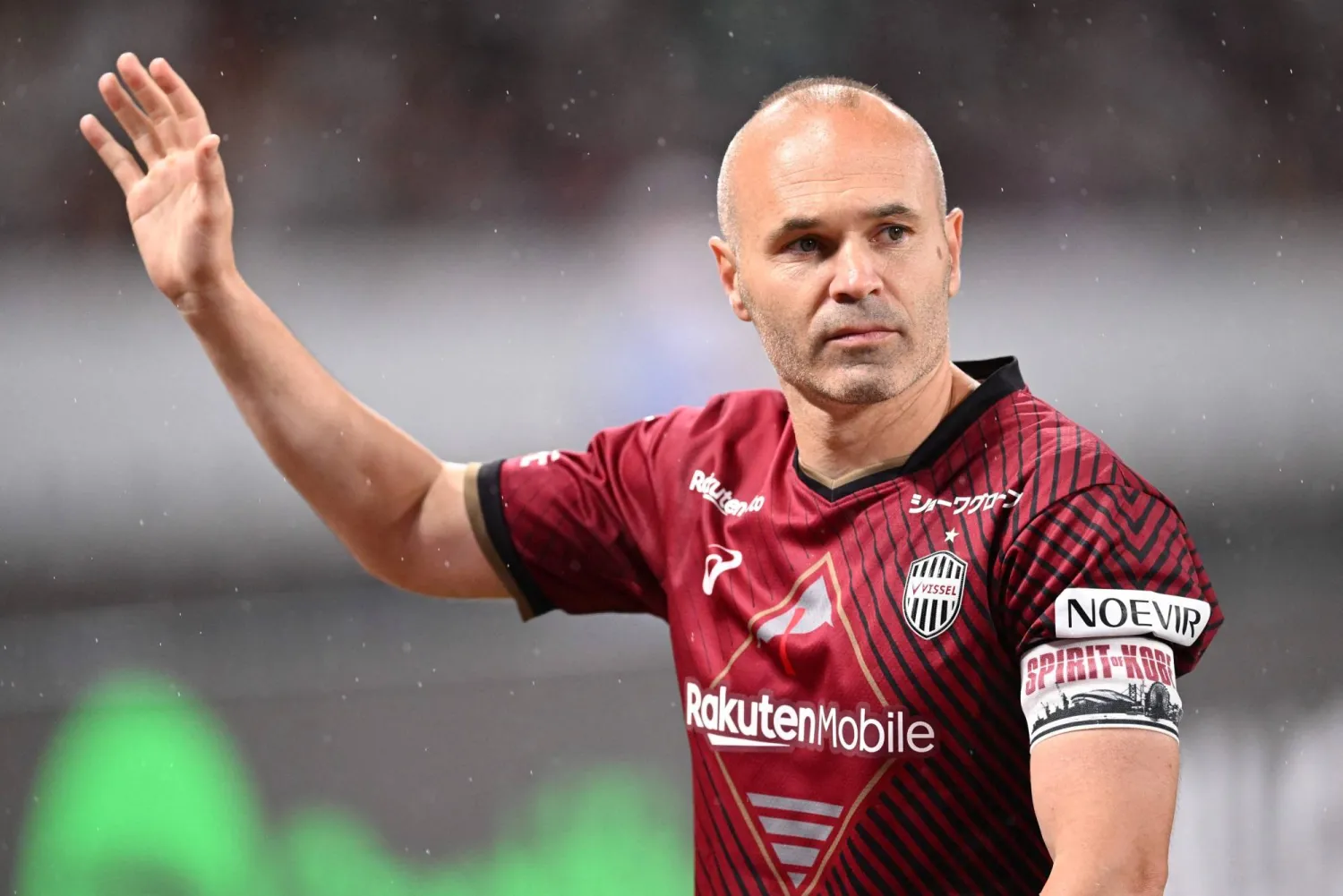 (FILES) Vissel Kobe's Andres Iniesta waves to supporters at the end of the football friendly between Japan's Vissel Kobe and Spanish side Barcelona at the Japan National Stadium in Tokyo on June 6, 2023. (Photo by Yuichi YAMAZAKI / AFP)