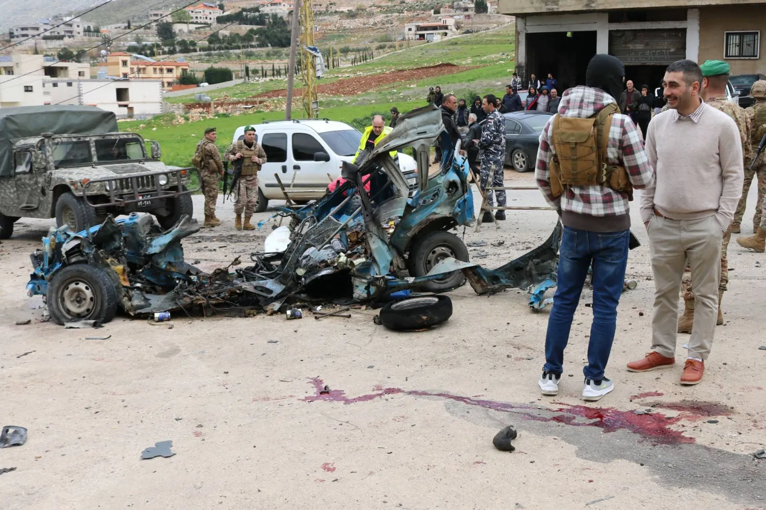 Lebanese soldiers cordon off the site of an Israeli drone attack targeting a vehicle in the town of Souairi, in western Bekaa Valley in central Lebanon on March 24, 2024. (Photo by Hassan JARRAH / AFP)
