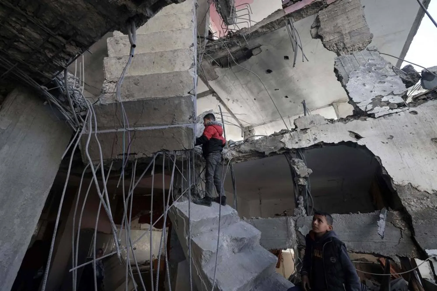  Palestinians inspect the damage to a building after overnight Israeli bombardment in Rafah in the southern Gaza Strip on March 25, 2024, amid the ongoing conflict between Israel and Hamas. (AFP)