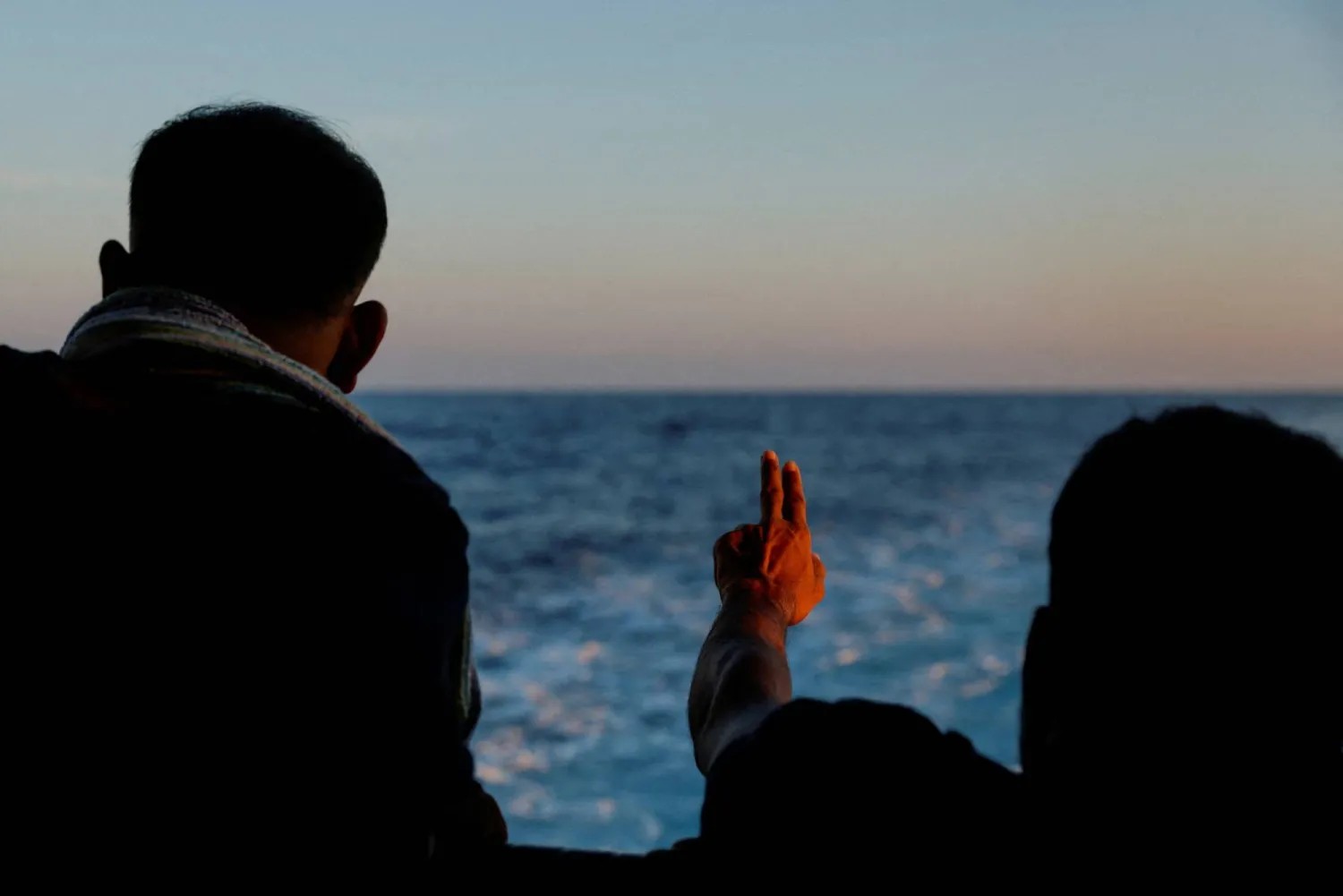 FILE PHOTO: A migrant gestures on the Geo Barents migrant rescue ship, operated by Medecins Sans Frontieres (Doctors Without Borders), as it makes its way to Italy after the rescue of 61 migrants on a wooden boat in international waters off the coast of Libya in the central Mediterranean Sea, September 30, 2023. REUTERS/Darrin Zammit Lupi 
