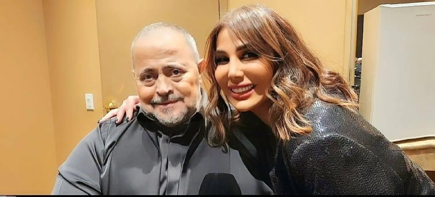 مع الفنان جورج وسوف خلال إحيائه حفلة له في كندا (يُمنى شرّي)