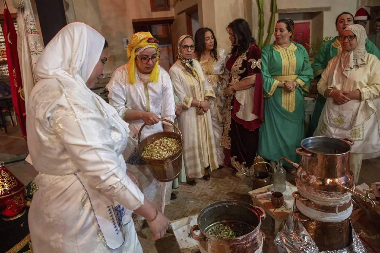 Women prepare to distill orange blossoms in a cultural center in Marrakech, Morocco, Saturday, March 23, 2024. (AP)