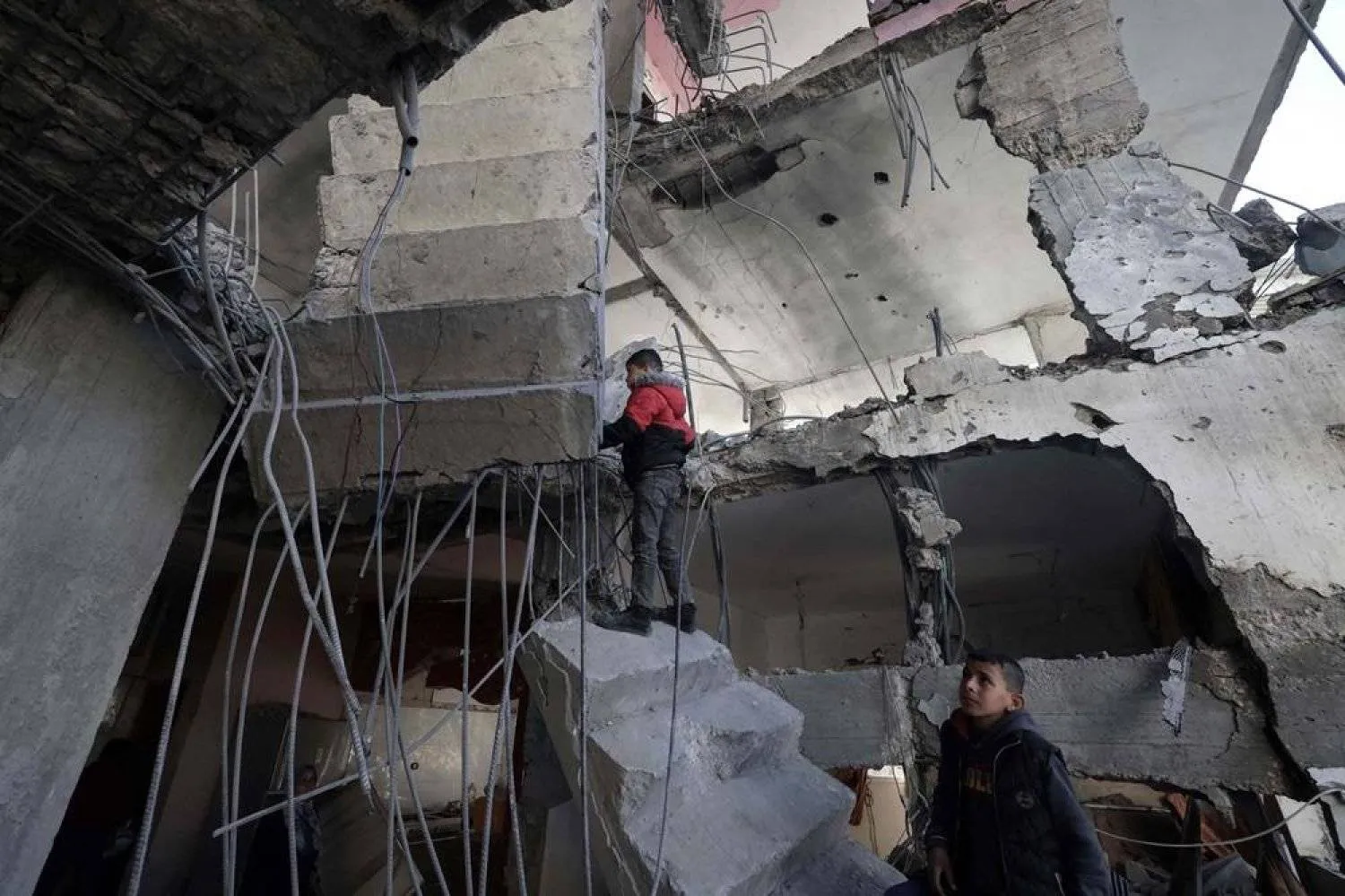 Palestinians inspect the damage to a building after overnight Israeli bombardment in Rafah in the southern Gaza Strip on March 25, 2024, amid the ongoing conflict between Israel and Hamas. (AFP)
