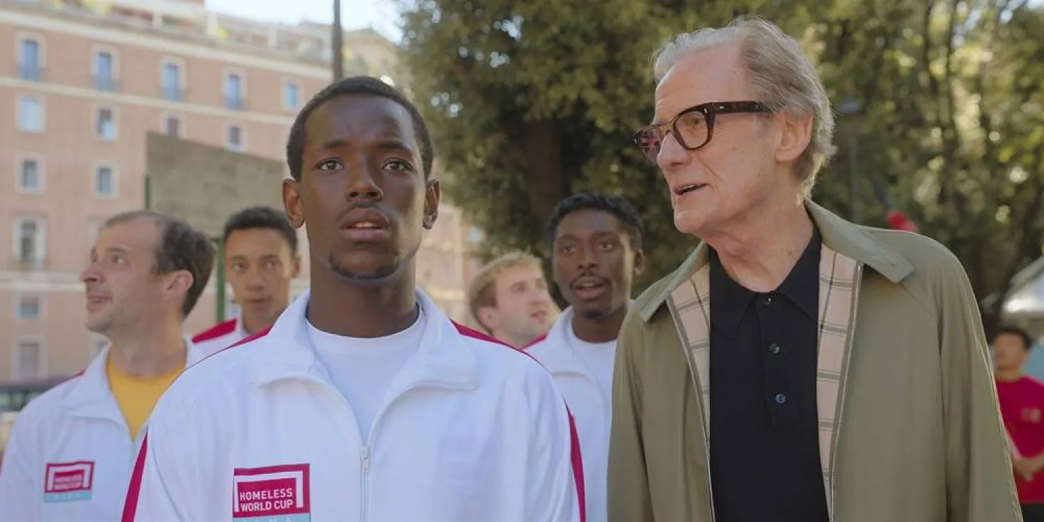  This image released by Netflix shows Micheal Ward, foreground left, and Bill Nighy in a scene from "The Beautiful Game." (Netflix via AP) 