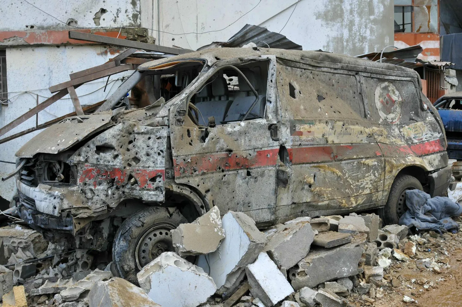 A damaged ambulance is seen at the site of an overnight Israeli airstrike in Habariyeh near the Israeli border on March 27, 2024. (Photo by Rabih DAHER / AFP)