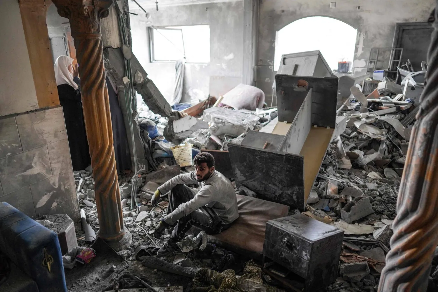 A Palestinian man inspects the rubble in a house, following Israeli bombardment, in the Maghazi camp for Palestinian refugees in the central Gaza Strip on March 29, 2024. (Photo by AFP)