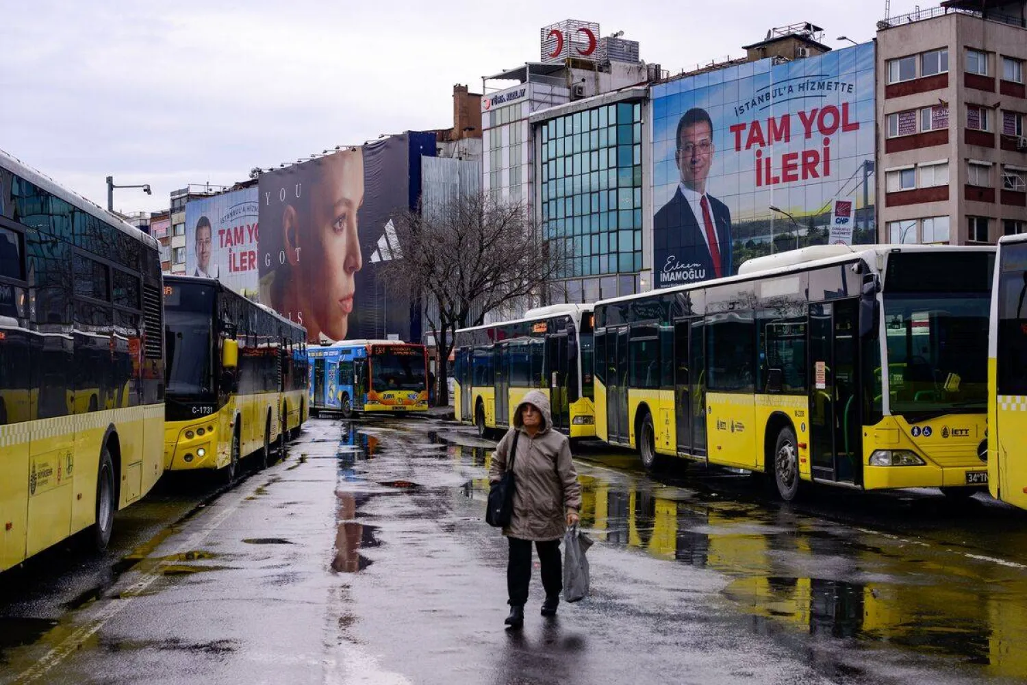 A pedestrian passes an electoral poster displaying Republican People's Party (CHP) candidate Ekrem Imamoglu in Istanbul on March 25.Photographer: Yasin Akgul/AFP/Getty Images
