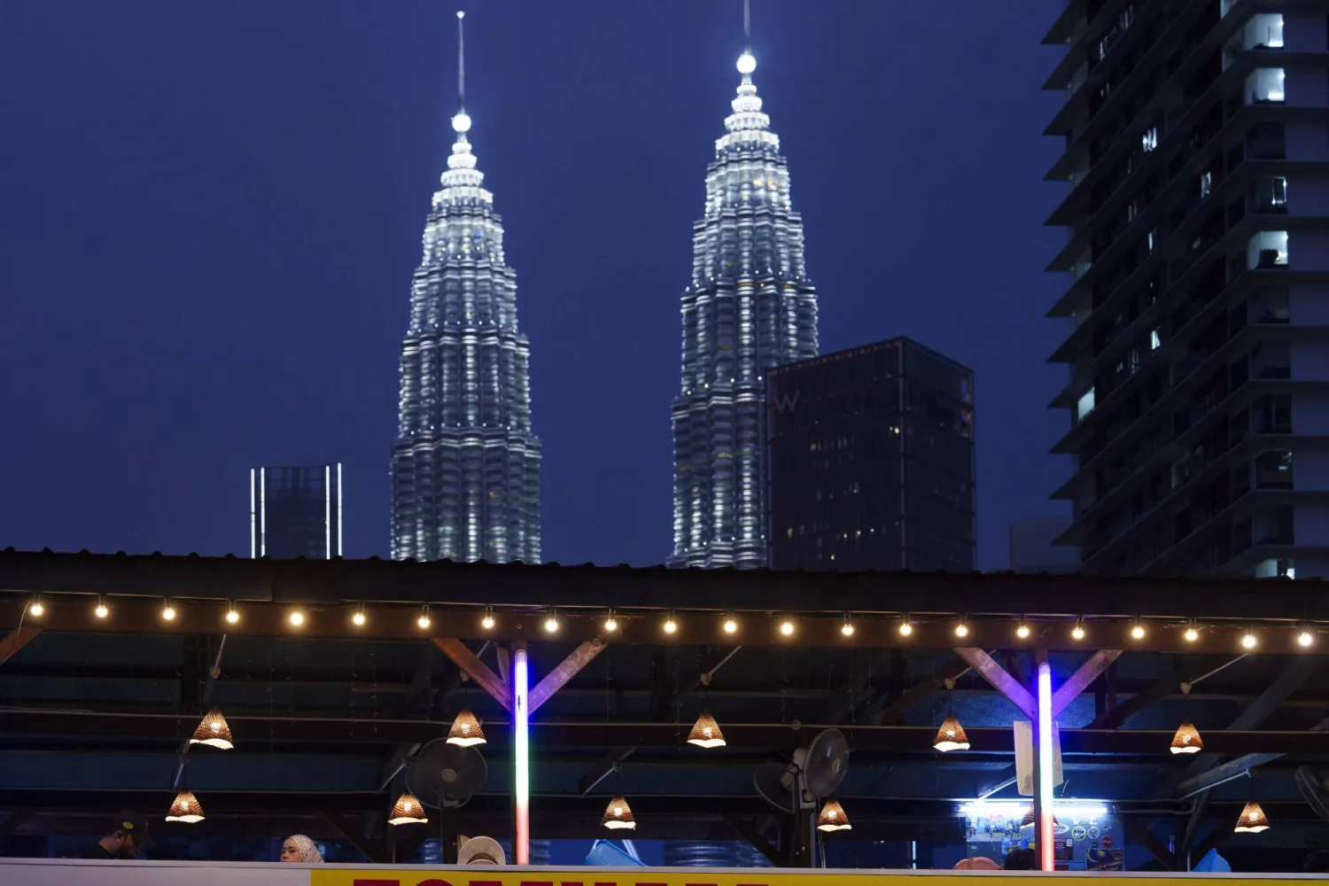 A Muslim family waiting to break their fast in the holy month of Ramadan in Kuala Lumpur, Malaysia, Monday, March 25, 2024. (AP Photo/Vincent Thian)
