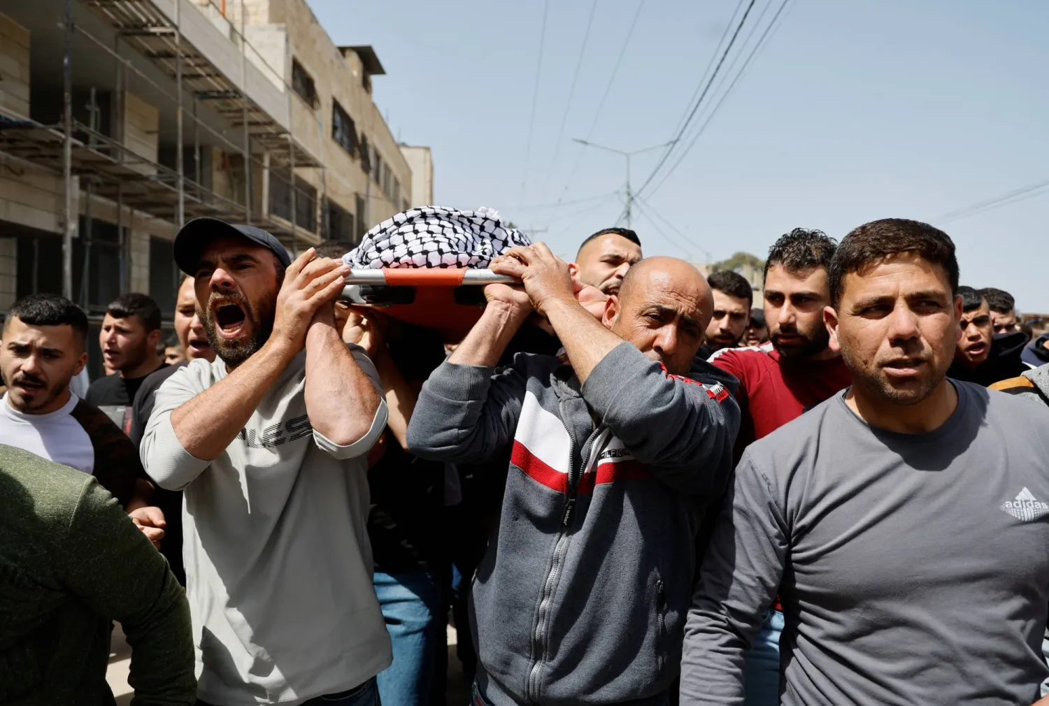 Mourners carry the body of Palestinian teen Mutasem Kameel, 13, who was killed in an Israeli raid, during his funeral near Jenin, in the Israeli-occupied West Bank, March 30, 2024. REUTERS/Raneen Sawafta