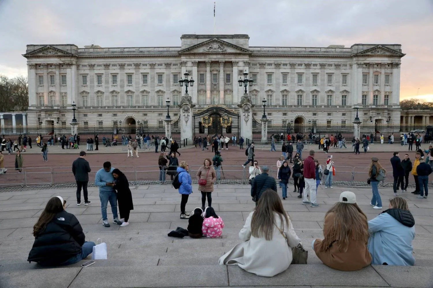 Tourists are seen outside Buckingham Palace in London, Britain. Reuters