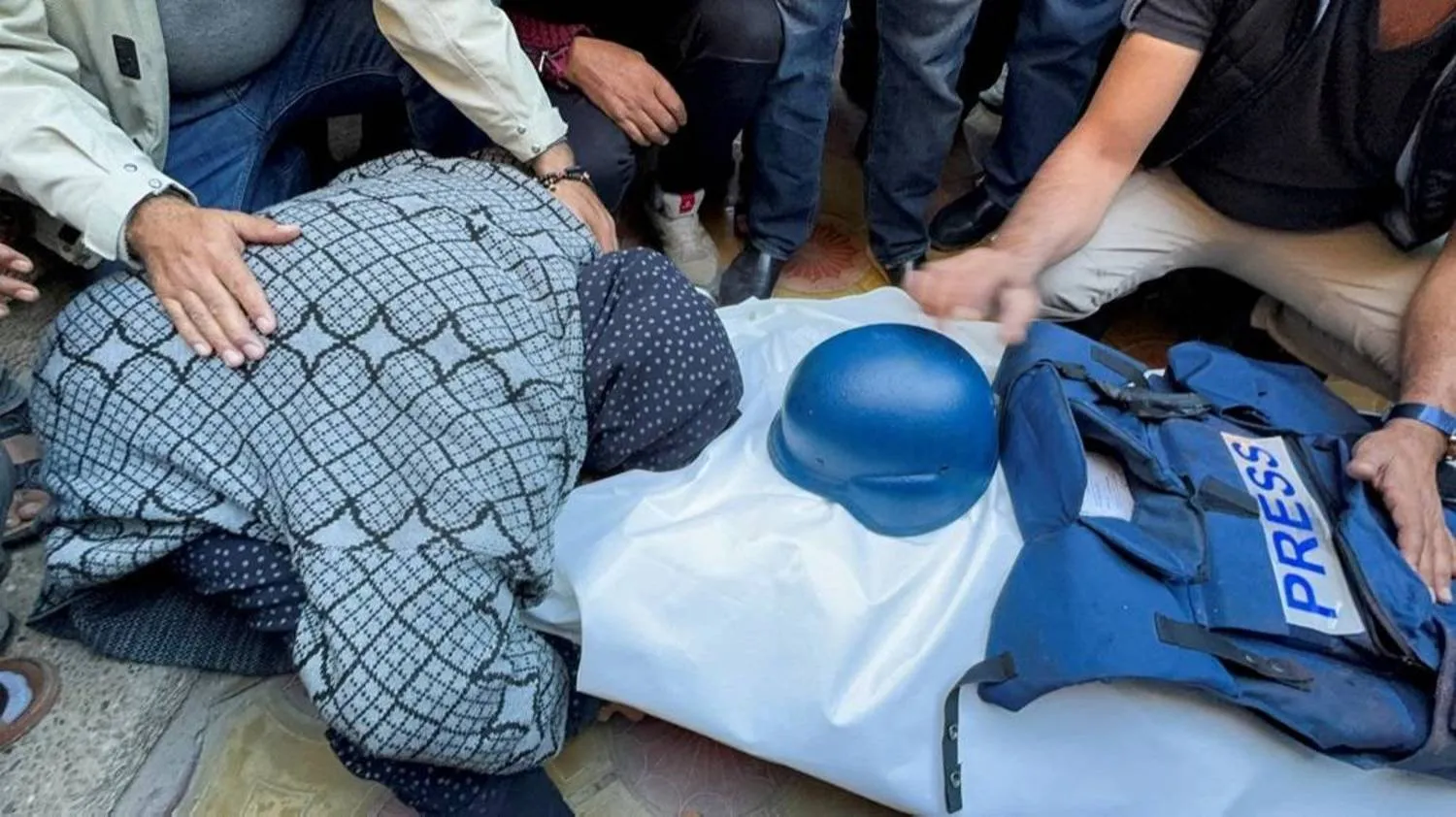 A mourner reacts as Palestinians attend the funeral of Al Jazeera cameraman Samer Abu Daqqa, who according to the Arabic broadcaster was killed by an Israeli drone strike on Friday while reporting on the earlier bombing of a school sheltering displaced people but Israel's military did not respond to a request for comment, in Khan Younis in the southern Gaza Strip December 16, 2023. (Reuters)
