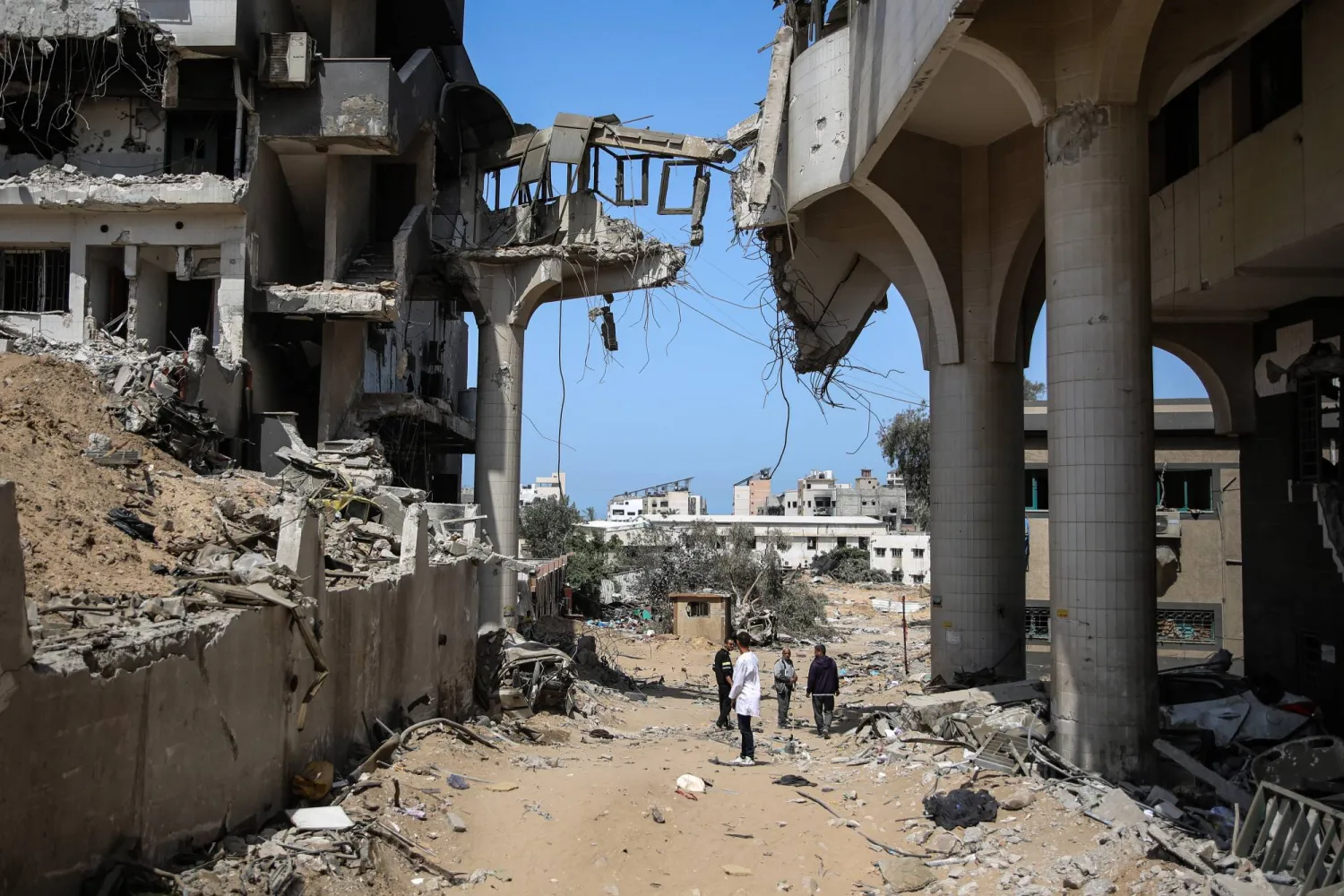 02 April 2024, Palestinian Territories, Gaza City: Palestinians inspect the damage at al-Shifa Hospital complex, following a two-week military operation by the Israeli army in Gaza City. Photo: Omar Ishaq/dpa