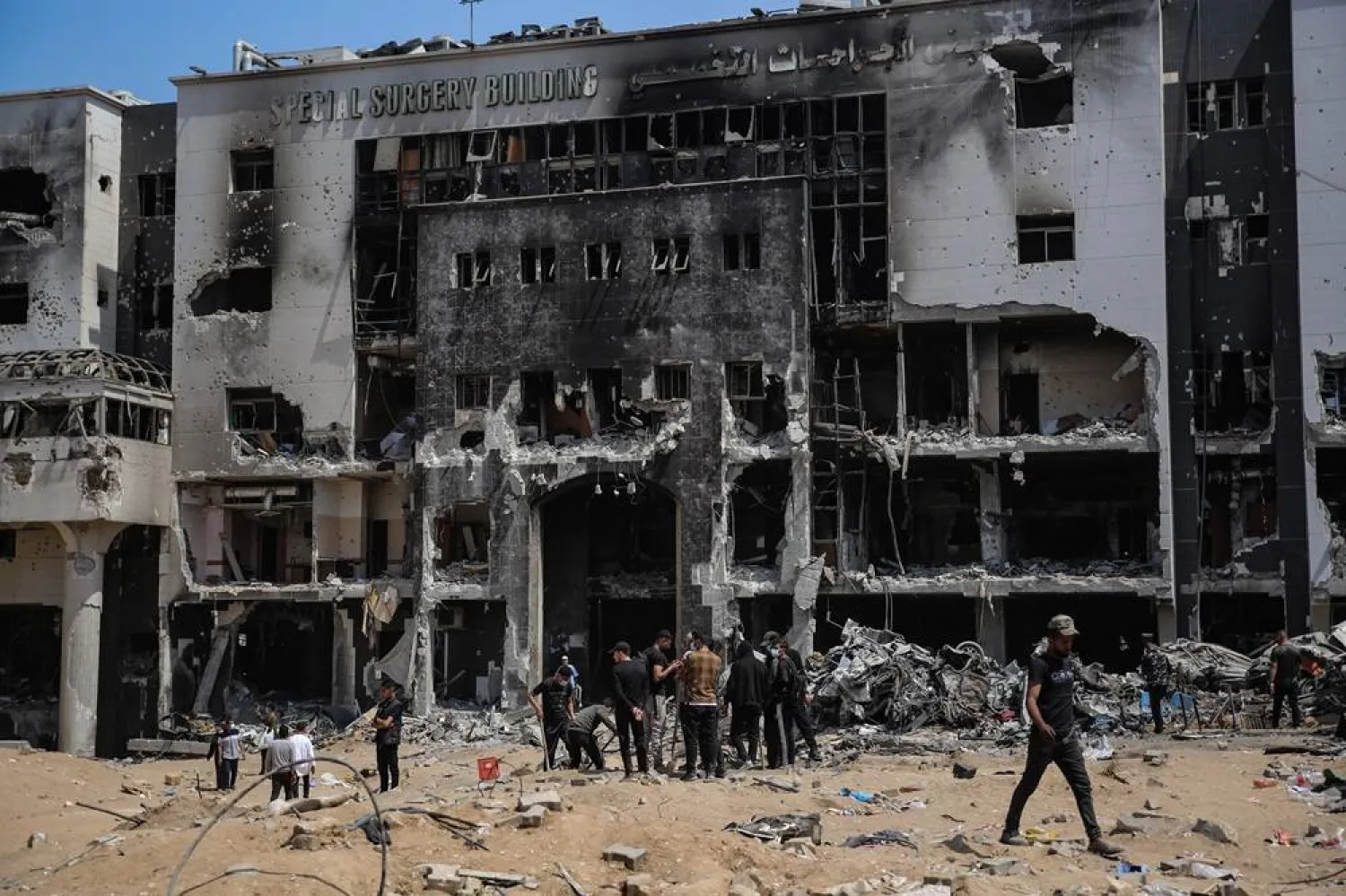  02 April 2024, Palestinian Territories, Gaza City: Palestinians inspect the damage at Al Shifa Hospital complex, following a two-week military operation by the Israeli army in Gaza City. (dpa)