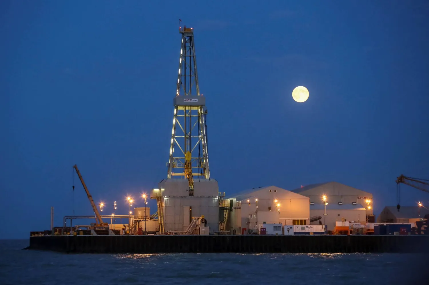FILE PHOTO: The full moon rises in the background over an oil rig at the Kashagan offshore oil field in the Caspian sea in western Kazakhstan August 21, 2013. REUTERS/Stringer/File Photo