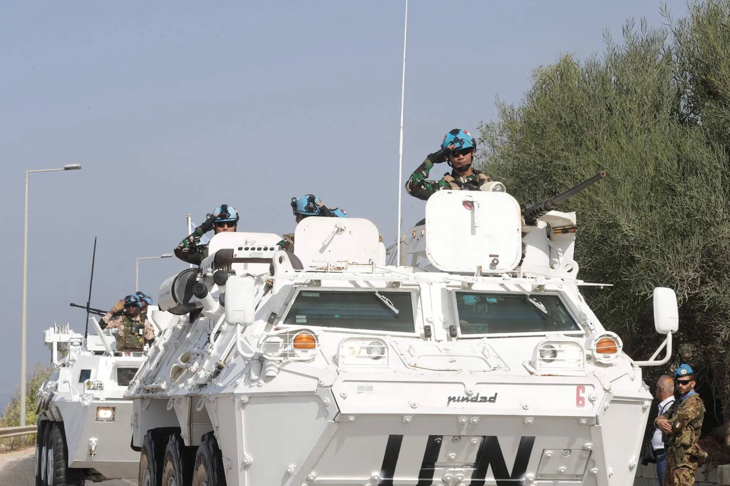 (FILES) United Nations peacekeeping force in Lebanon (UNIFIL) vehicles drive along the main road leading to Lebanon's southern town of Naqura, close to the border with Israel on October 27, 2022. (Photo by MAHMOUD ZAYYAT / AFP)