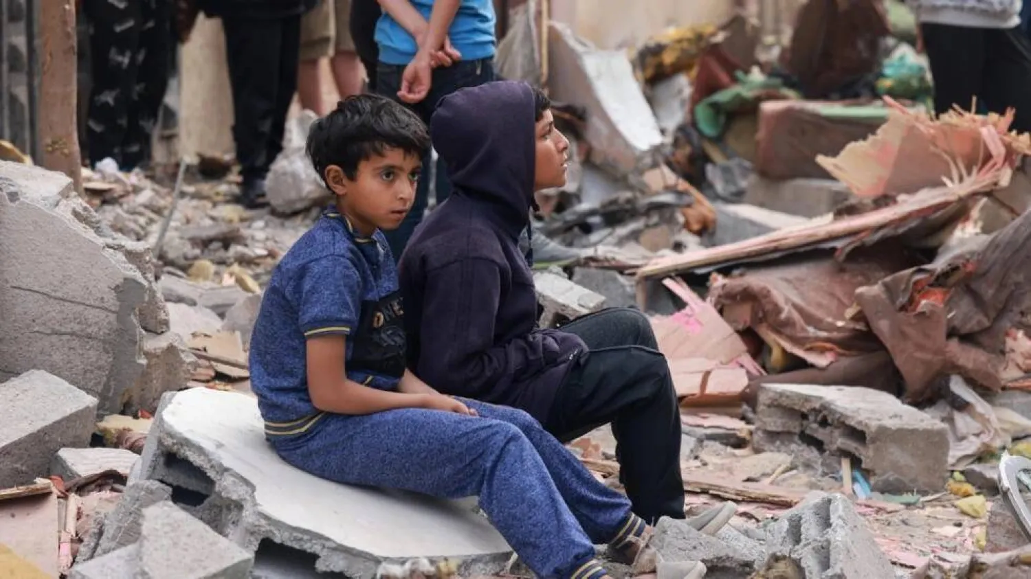 Palestinian boys sit on building rubble following overnight Israeli bombardment in Rafah in the southern Gaza Strip. MOHAMMED ABED / AFP
