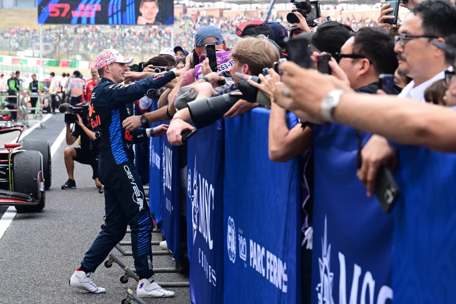 Red Bull Racing's Dutch driver Max Verstappen (L) celebrates his victory with his team at the end of the Formula One Japanese Grand Prix race at the Suzuka circuit in Suzuka, Mie prefecture on April 7, 2024. (Photo by Yuichi YAMAZAKI / AFP)