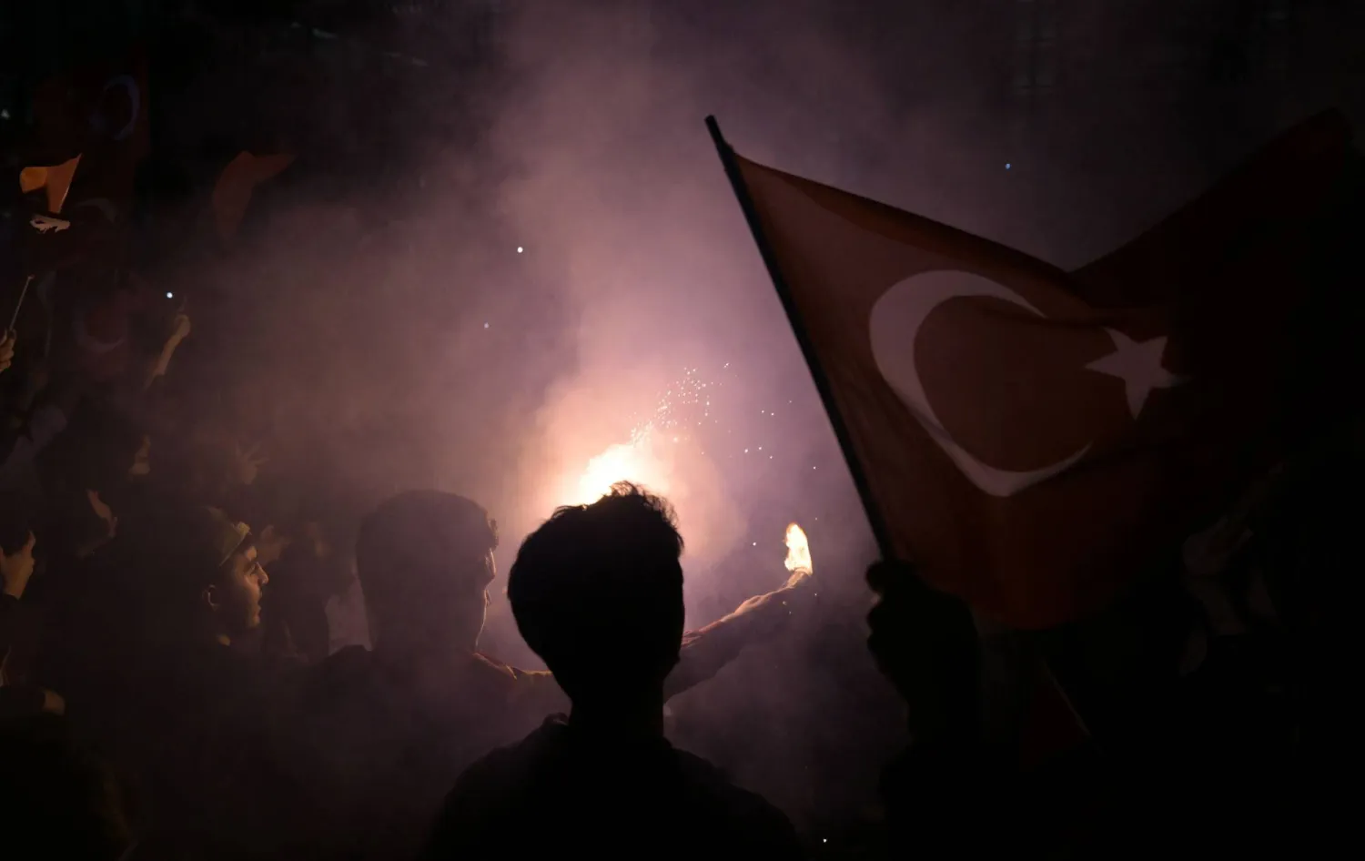 Opposition Republican People's Party (CHP) supporters celebrate outside the main municipality building following municipal elections across Türkiye, in Istanbul on March 31, 2024. (Photo by OZAN KOSE / AFP)