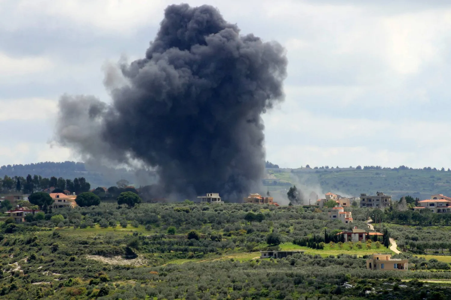 Smoke billows after an Israeli strike on the southern Lebanese border village of Tayr Harfa on April 6, 2024. (Photo by KAWNAT HAJU / AFP)