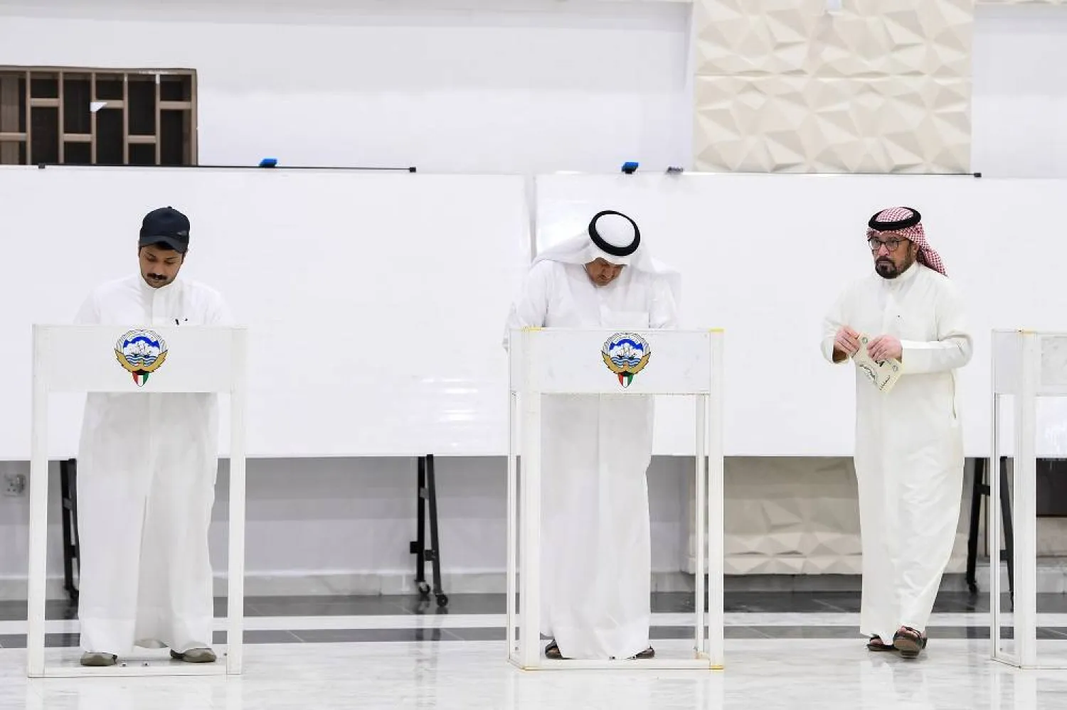 Men prepare to cast their votes during the parliamentary elections at a polling station, in Kuwait City, Kuwait, 04 April 2024. (EPA)