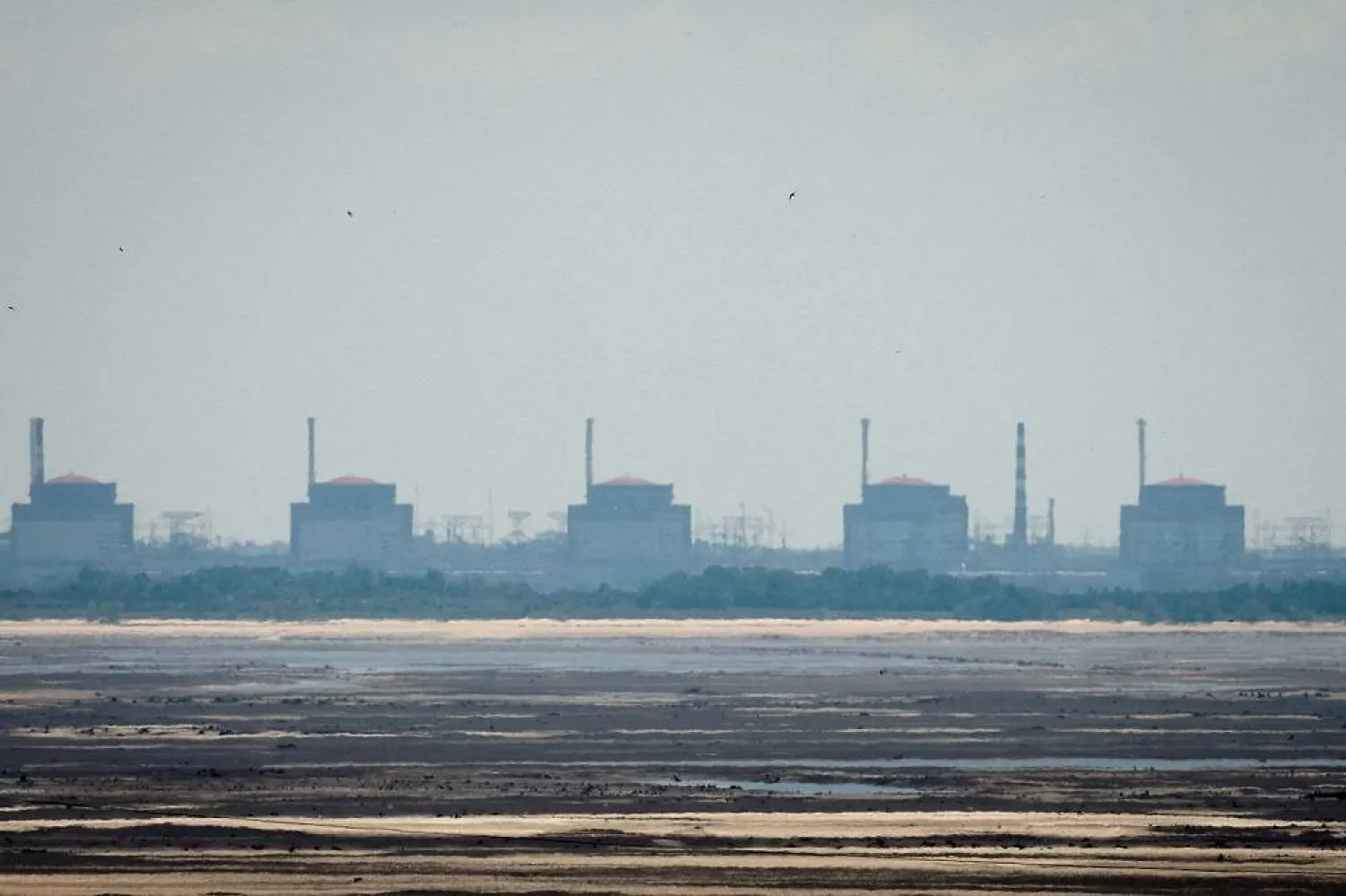 A view shows Zaporizhzhia Nuclear Power Plant from the bank of Kakhovka Reservoir near the town of Nikopol after the Nova Kakhovka dam breached, amid Russia's attack on Ukraine, in Dnipropetrovsk region, Ukraine June 16, 2023. (Reuters)