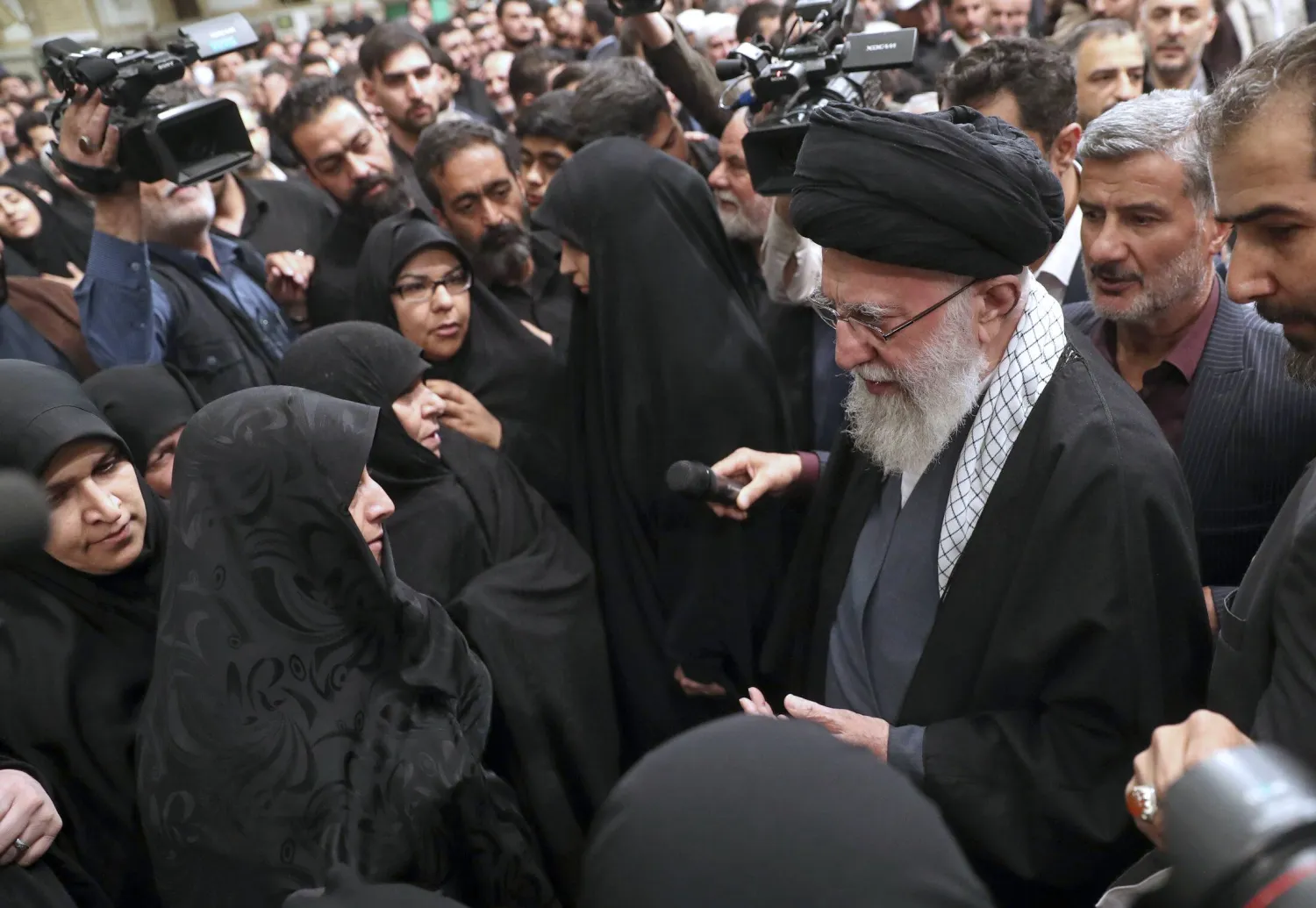 In this photo released by an official website of the office of the Iranian supreme leader, Supreme Leader Ali Khamenei, right, greets families of the Revolutionary Guards members who were killed in an airstrike in Syria on Monday widely blamed on Israel, in Tehran, Iran, Thursday, April 4, 2024. (Office of the Iranian Supreme Leader via AP)
