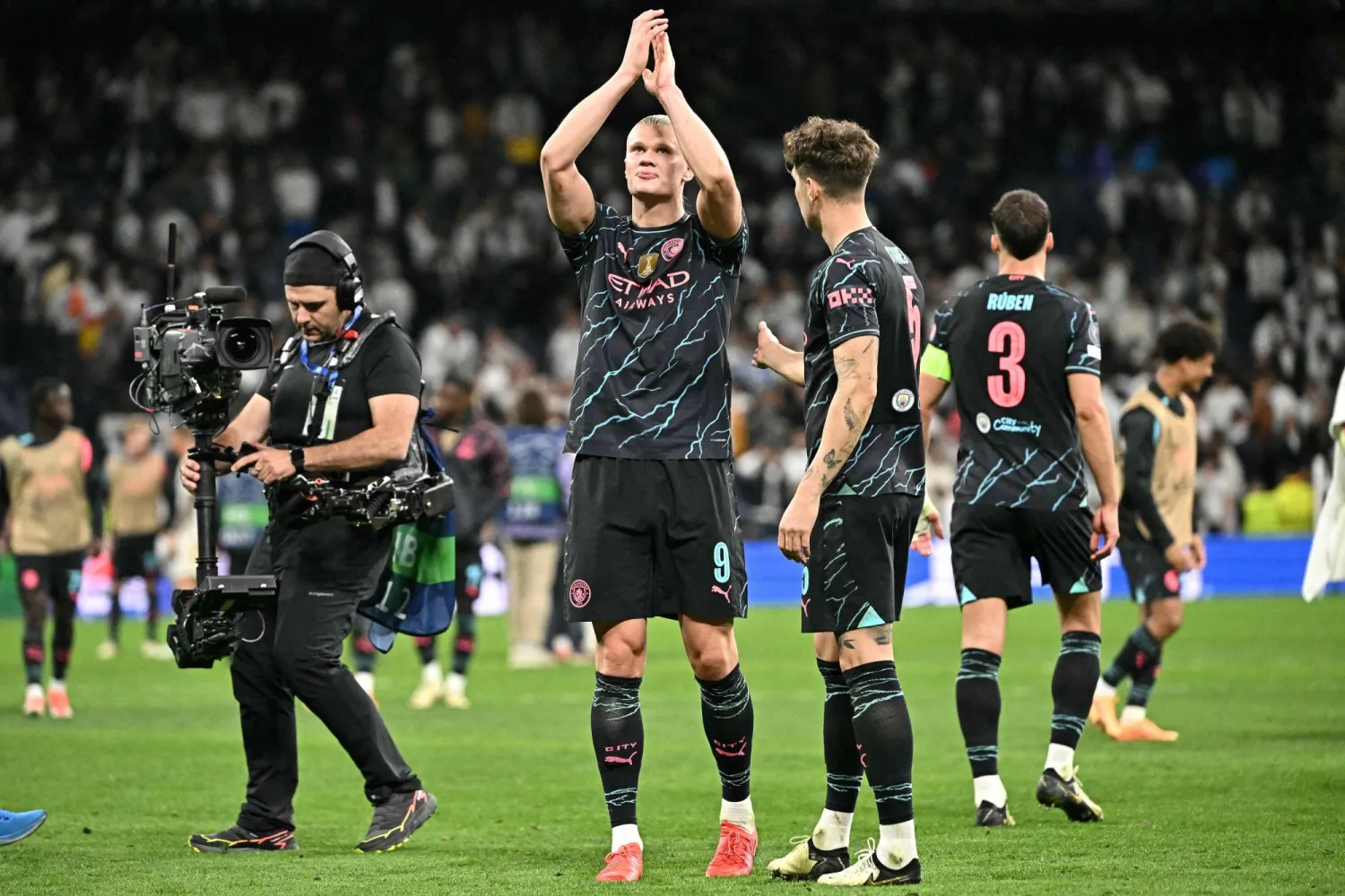 Manchester City's Norwegian striker #09 Erling Haaland applauds at the end of the UEFA Champions League quarter final first leg football match between Real Madrid CF and Manchester City at the Santiago Bernabeu stadium in Madrid on April 9, 2024. The match ended in a 3-3 draw. (Photo by JAVIER SORIANO / AFP)