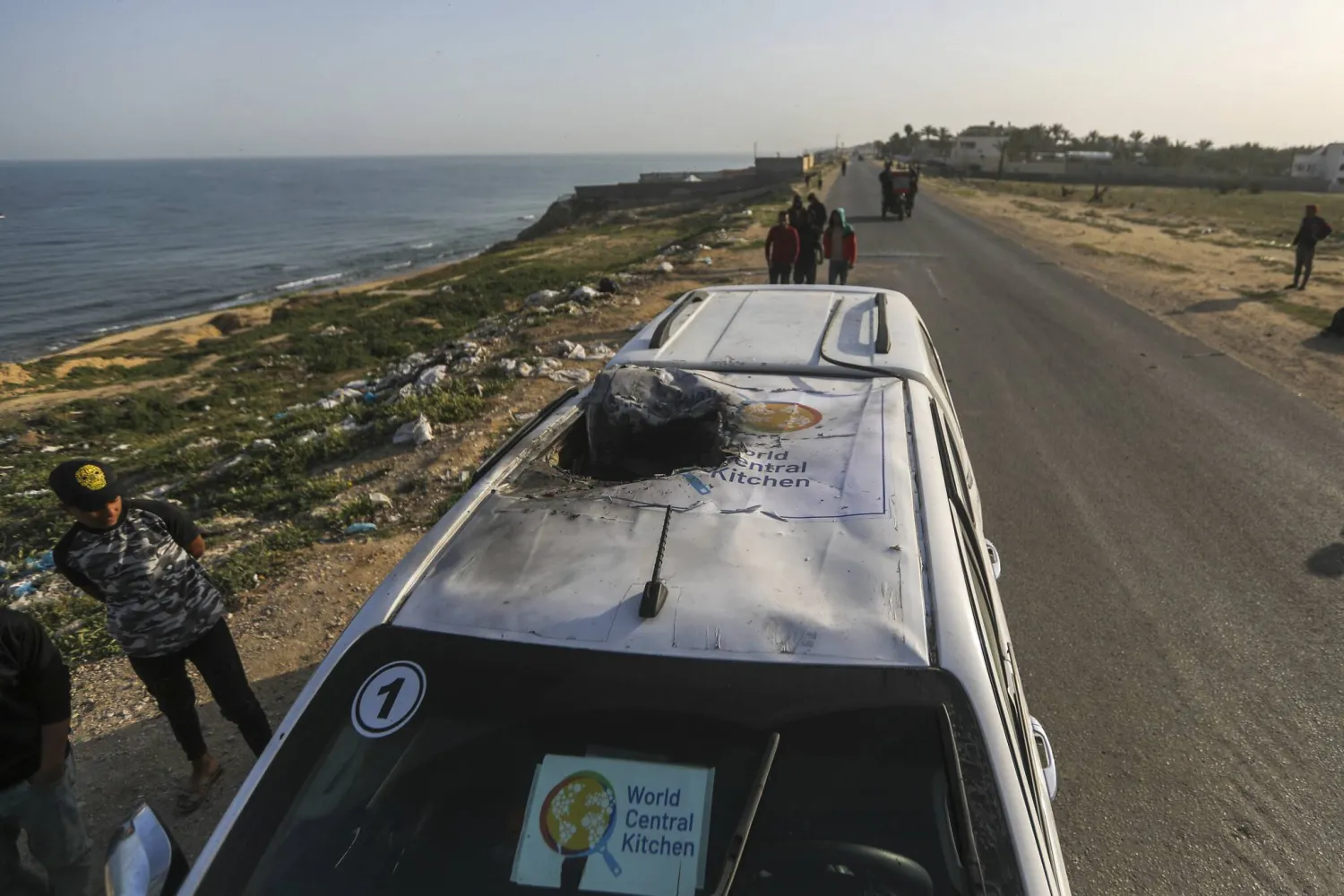 Palestinians inspect a vehicle with the logo of the World Central Kitchen wrecked by an Israeli airstrike in Deir al Balah, Gaza Strip, April 2, 2024. (Ismael Abu Dayyah/AP)
