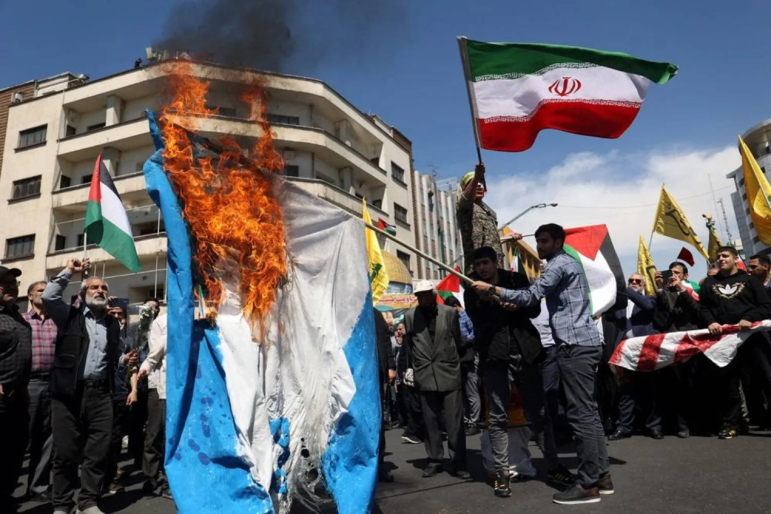 Iranians burn an Israeli flag during a rally marking Quds Day and the funeral of members of the Iranian Revolutionary Guard Corps who were killed in a suspected Israeli airstrike on the Iranian embassy complex in the Syrian capital Damascus, in Tehran, Iran, April 5, 2024. Majid Asgaripour/WANA (West Asia News Agency) via Reuters