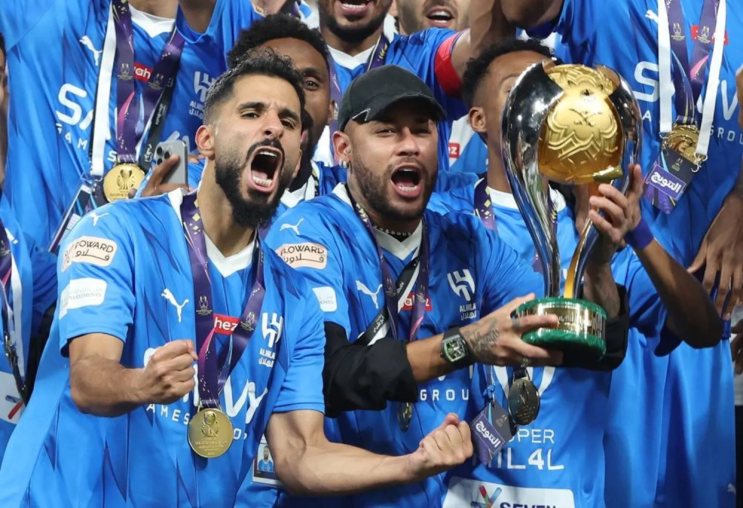 Neymar (C) of Al-Hilal poses with the trophy on the podium after winning the Saudi Super Cup final between Al-Ittihad and Al-Hilal in Abu Dhabi, United Arab Emirates, 11 April 2024. (EPA)