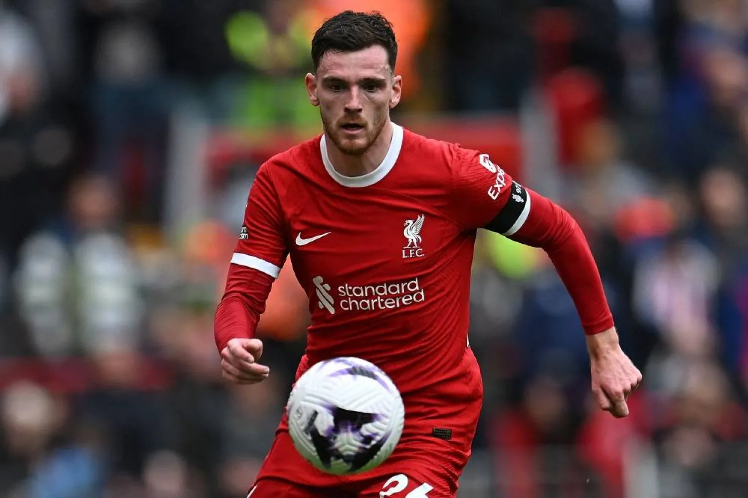 Liverpool's Scottish defender #26 Andrew Robertson runs with the ball during the English Premier League football match between Liverpool and Crystal Palace at Anfield in Liverpool, north west England on April 14, 2024. (AFP)
