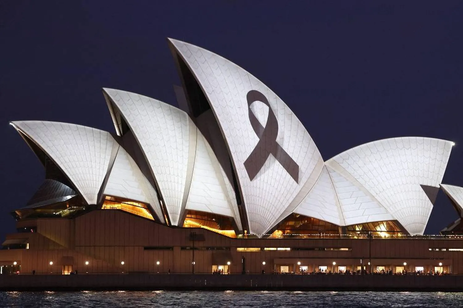 A black ribbon is projected onto the Sydney Opera House on April 15, 2024, as a mark of respect for the victims of the Westfield Bondi Junction shopping mall attack. (AFP)