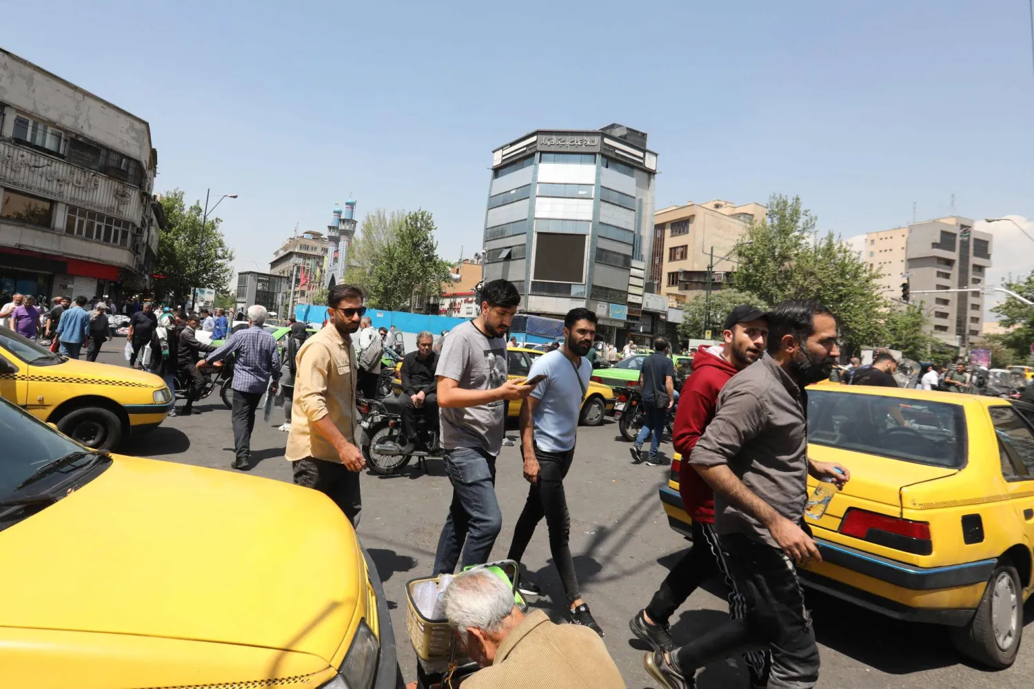 People buy spices and dried fruits at the Grand Bazaar in Tehran, on April 21, 2024. (Photo by ATTA KENARE / AFP)