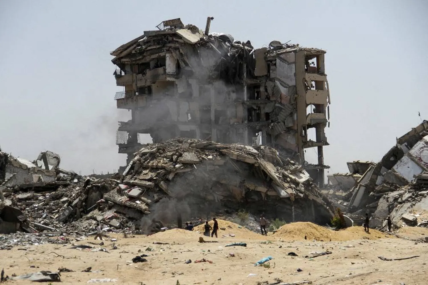 Palestinians walk past the rubble of residential buildings destroyed by Israeli strikes, amid the ongoing conflict between Israel and Hamas, in the northern Gaza Strip, April 22, 2024. (Reuters)