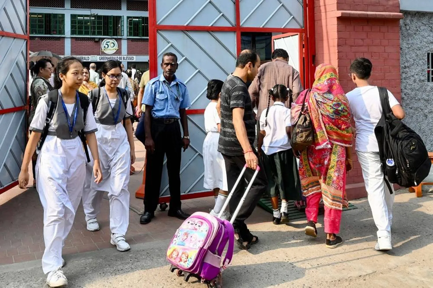 Students arrive to attend classes on a hot summer day, at a school in Dhaka on April 28, 2024, amid the ongoing heatwave. (AFP)