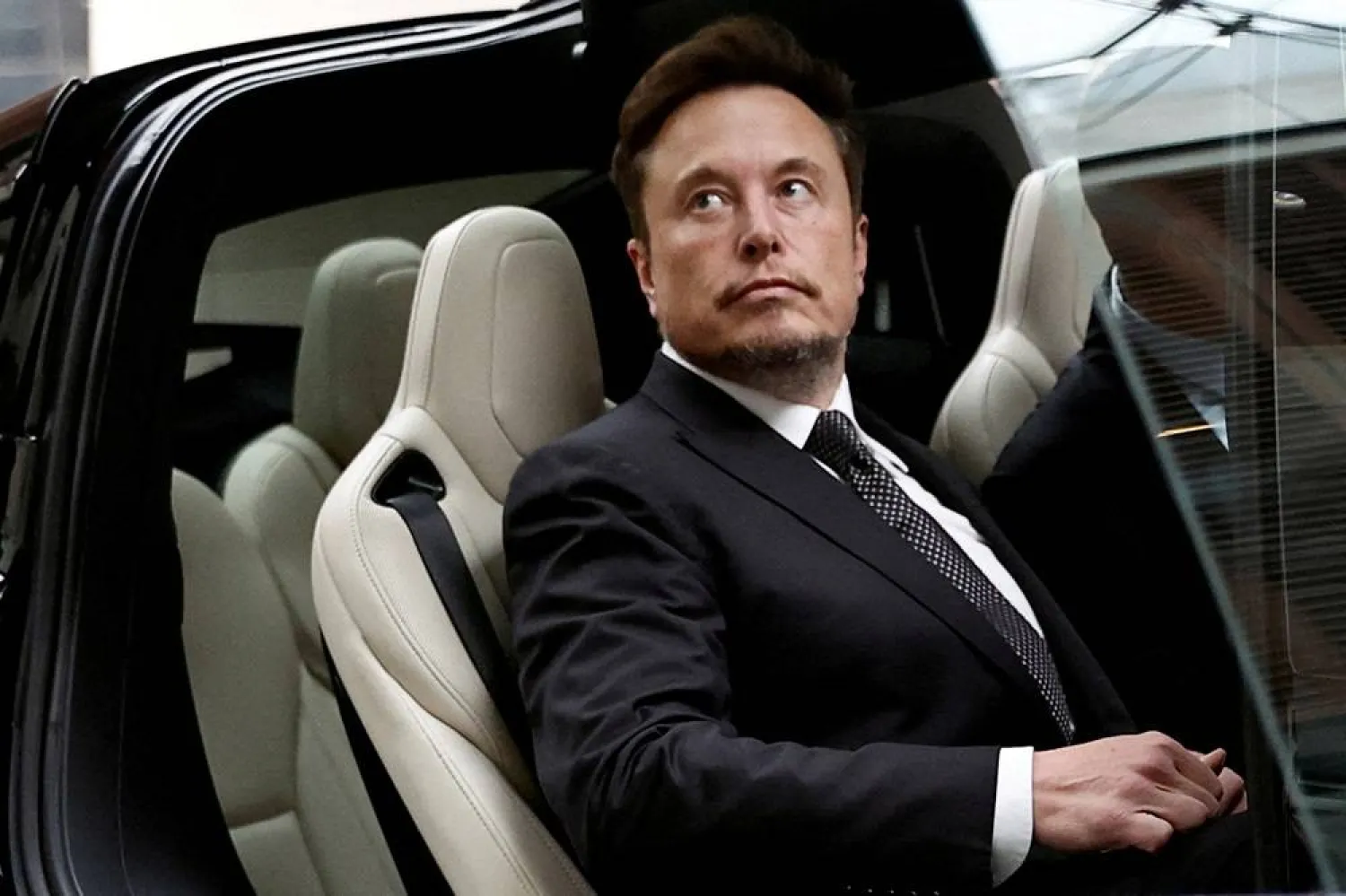 Tesla Chief Executive Officer Elon Musk gets in a Tesla car as he leaves a hotel in Beijing, China May 31, 2023. (Reuters)