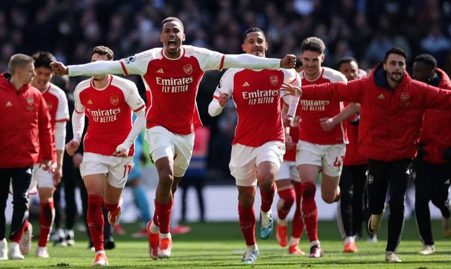 Gabriel (L) of Arsenal and his teammates celebrate their 3-2 win after the English Premier League soccer match between Tottenham Hotspur against Arsenal FC in London, Britain, 28 April 2024. (EPA)
