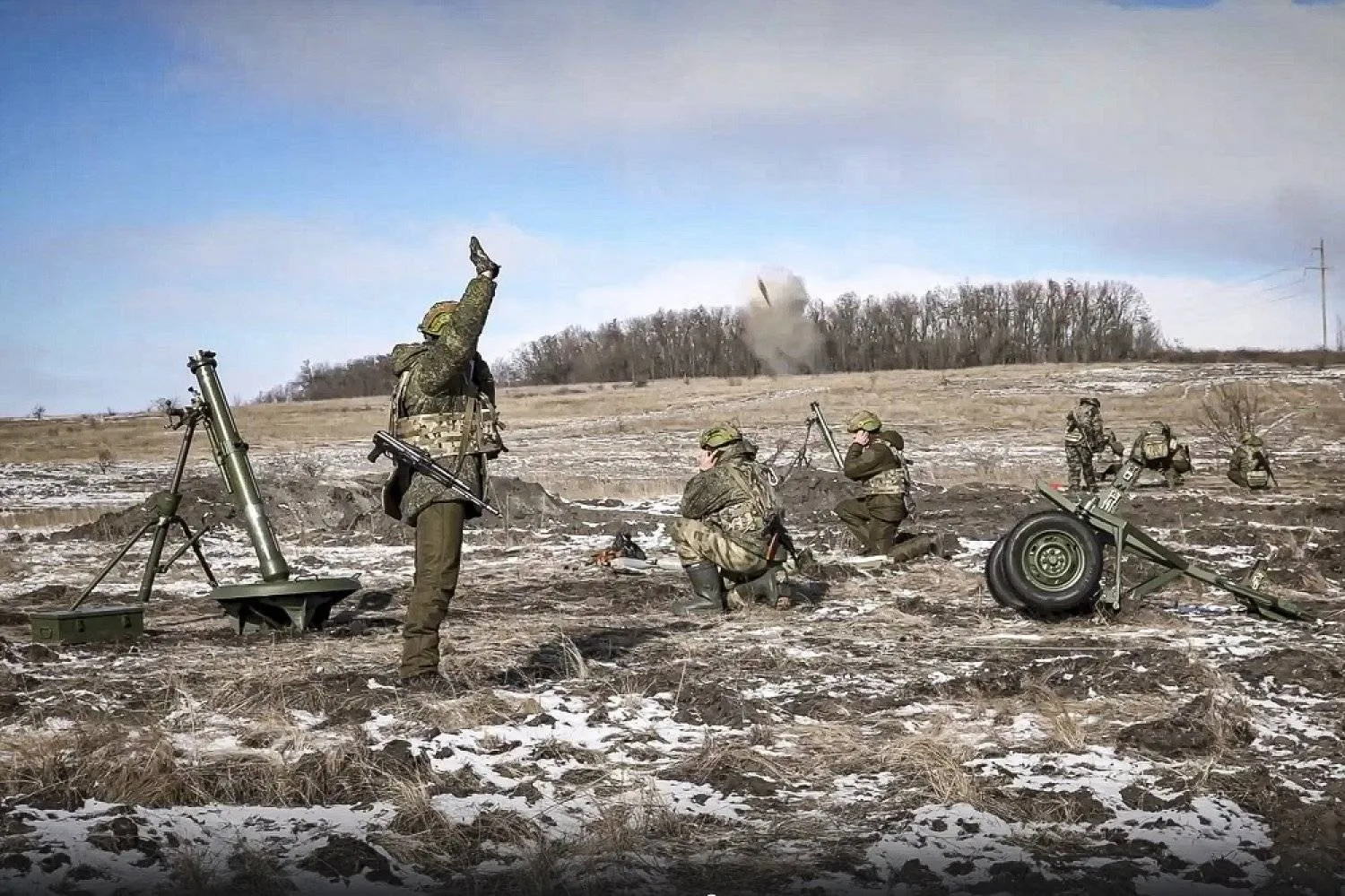 In this handout photo taken from video and released by Russian Defense Ministry Press Service on Friday, Feb. 17, 2023, the Russian army's 120 mm mortars fire at Ukrainian troops at an undisclosed location. (Russian Defense Ministry Press Service via AP)
