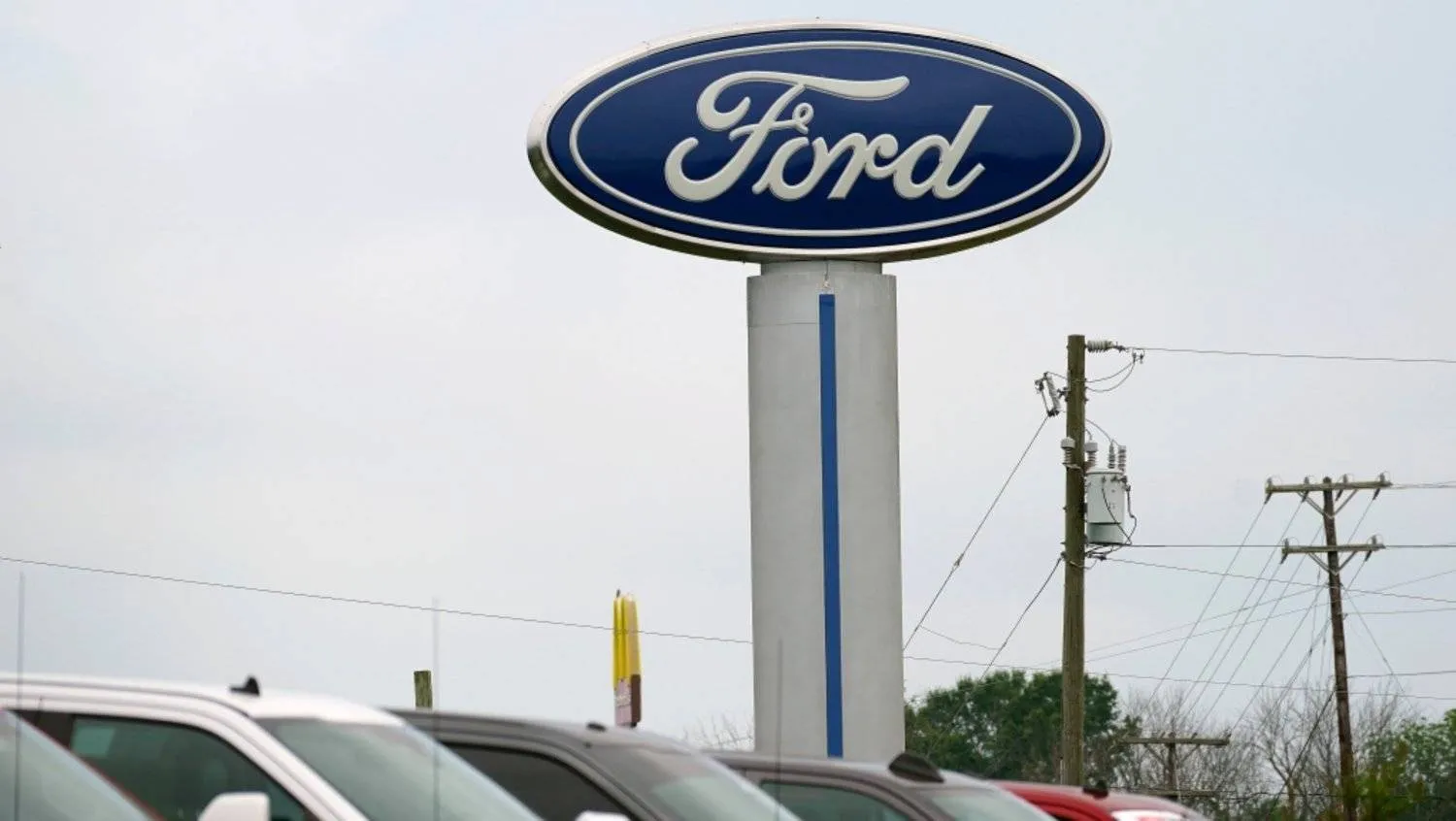 A Ford logo is seen on signage at Country Ford in Graham, N.C., Tuesday, July 27, 2021. (AP Photo/Gerry Broome)
