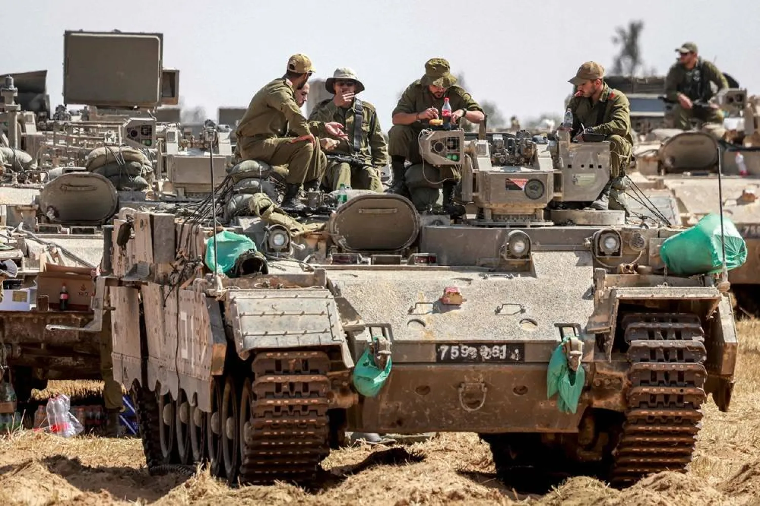 Israeli army soldiers sit atop an infantry-fighting vehicle (IFV) stationed at a position near the border with the Gaza strip in southern Israel on April 30, 2024, amid the ongoing conflict in the Palestinian territory between Israel and the group Hamas. (AFP) 