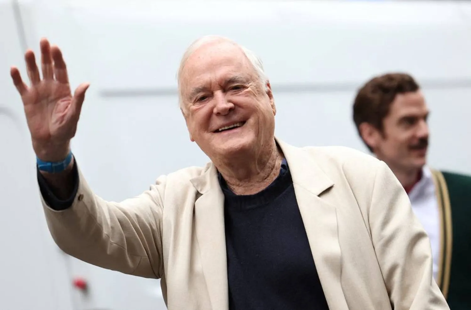 British actor John Cleese waves as he arrives for a photocall promoting the theatrical remake of his 1975 television program “Fawlty Towers” at the Apollo Theater in London, Britain, May 2, 2024. (Reuters)