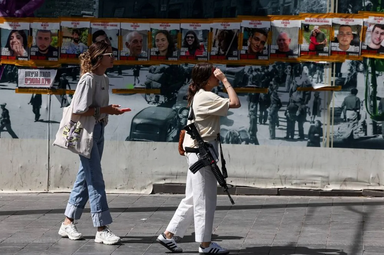  People walk near posters calling for the release of hostages who were kidnapped during the deadly October 7 attack by the Palestinian group Hamas, amid the ongoing conflict in Gaza between Israel and Hamas, in Jerusalem, May 3, 2024. (Reuters)