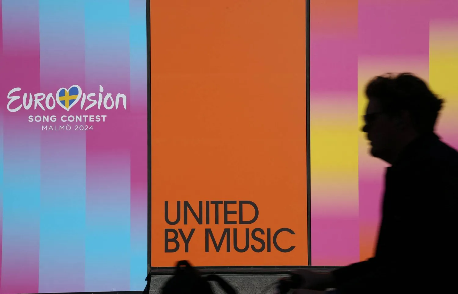 A person walks past a sign for the Eurovision Song Contest outside the Malmo Arena, the venue for the contest, in Malmo, Sweden, May 2, 2024. REUTERS/ Tom Little/File Photo
