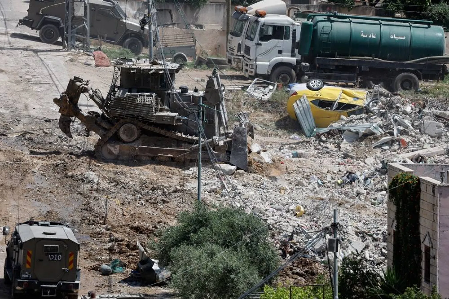  A military bulldozer operates during an Israeli raid in Deir al-Ghusun, in the Israeli occupied West Bank, May 4, 2024. (Reuters)