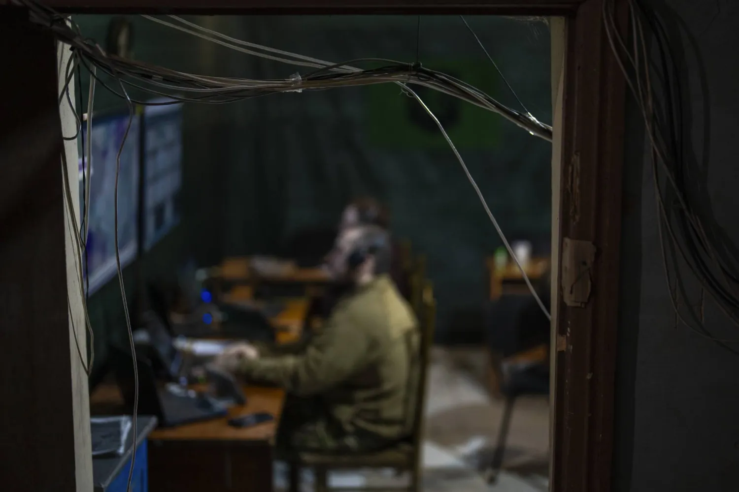 Service men of the 13th Brigade of Operational Assignment of the NGU "Khartia" of the National Guard of Ukraine look at screens in a drone command point in Avdiivka direction, Ukraine, Saturday, May 4, 2024. (AP Photo/Francisco Seco)