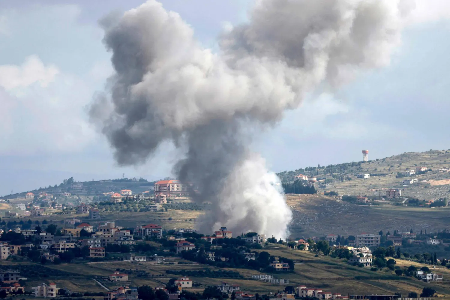 This picture taken from the northern Israeli kibbutz of Malkia along the border with southern Lebanon, shows smoke billowing above the Lebanese village of Meiss El-Jabal during Israeli bombardment on May 5, 2024. (Photo by Jalaa MAREY / AFP)